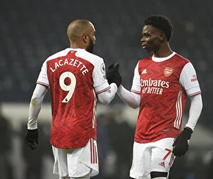 Images Dated 2nd January 2021: Arsenal's Lacazette and Saka Celebrate Third Goal vs. West Bromwich Albion (2020-21)