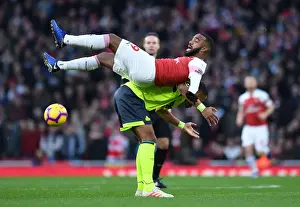 Arsenal's Lacazette Tangles with Huddersfield's Jorgensen in Premier League Clash