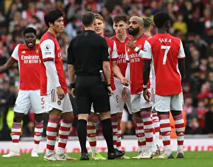 Arsenal's Lacazette and Tomiyasu Confer with Referee during Arsenal vs Manchester City (2021-22)