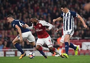 Arsenal v West Bromwich Albion 2017-18 Collection: Arsenal's Lacazette Tripped by Evans and Barry in Premier League Clash vs. West Bromwich Albion