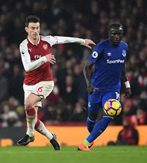 Arsenal V Everton 2017-18 Prints: Arsenal's Laurent Koscielny Clashes with Everton's Oumar Niasse in Premier League Showdown