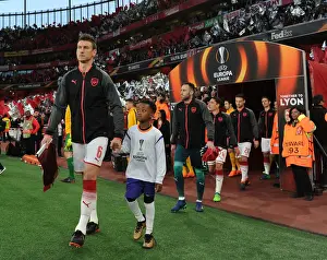 Arsenal's Laurent Koscielny Leads Out Team Against Atletico Madrid in Europa League Semi-Final