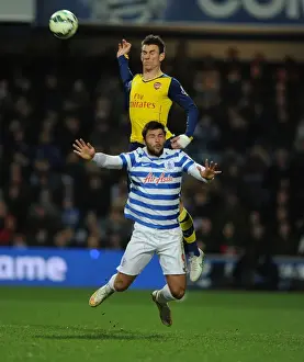 Queens Park Rangers V Arsenal 2014-15 Prints: Arsenal's Laurent Koscielny Soars Above QPR's Charlie Austin in Premier League Clash