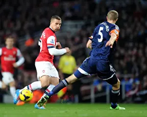 Arsenal V Fulham 2013-14 Prints: Arsenal's Lukas Podolski Clashes with Fulham's Brede Hangeland during the 2013-14 Premier League Match