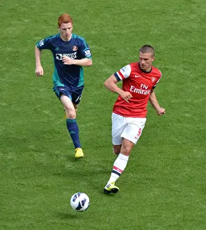 Arsenal V Sunderland 2012-13 Prints: Arsenal's Lukas Podolski Faces Off Against Sunderland's Jack Colback at Emirates Stadium