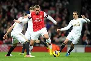 Arsenal V Swansea 2012-13 Prints: Arsenal's Lukas Podolski Fends Off Chico Flores and Leon Britton of Swansea during the 2012-13 Premier League Match