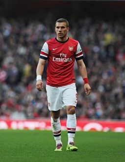 Images Dated 29th March 2014: Arsenal's Lukas Podolski Fights for Possession Against Manchester City, Premier League 2013/14