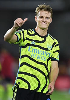 Images Dated 27th September 2023: Arsenal's Martin Odegaard Acknowledges Fans after Brentford Cup Victory (2023-24)