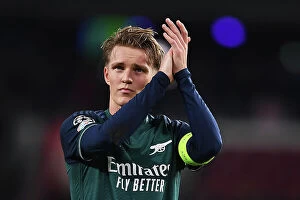 Images Dated 12th December 2023: Arsenal's Martin Odegaard Applauding Fans: PSV Eindhoven vs Arsenal, UEFA Champions League 2023-24