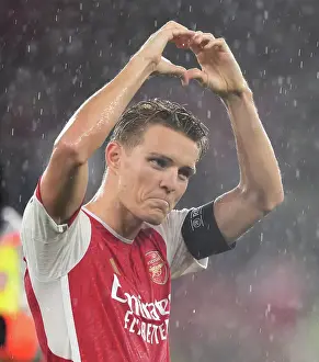 Arsenal's Martin Odegaard Celebrates with Fans after Winning Heart of the Crowd vs. PSV Eindhoven (UEFA Champions League 2023/24)