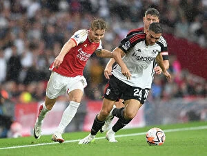 Images Dated 26th August 2023: Arsenal's Martin Odegaard Clashes with Fulham's Joao Palhinha in Premier League Showdown at
