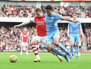 Arsenal v Manchester City 2021-22 Collection: Arsenal's Martin Odegaard Clashes with Manchester City's Rodri