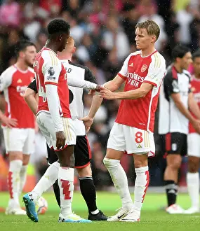 Arsenal's Martin Odegaard and Eddie Nketiah Connect Amidst Premier League Action: Arsenal FC vs Fulham FC (2023-24)