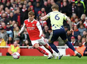 Arsenal's Martin Odegaard Fends Off Leeds United's Liam Cooper: Premier League Clash at Emirates Stadium (April 2023)