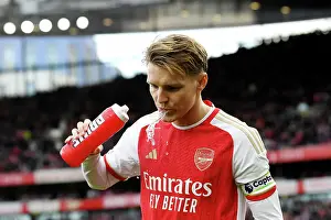 Arsenal's Martin Odegaard Sips Prime Beverage Before Arsenal vs Brighton & Hove Albion (2023-24)