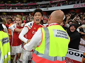 Arsenal's Martin Odegaard and Takehiro Tomiyasu Celebrate Gabriel Martinelli's Goal Against Manchester City (2023-24)