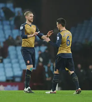 Aston Villa V Arsenal 2015-16 Prints: Arsenal's Per Mertesacker and Laurent Koscielny Share a Heartfelt Moment After Aston Villa Match