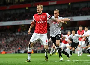 Arsenal V Fulham 2012-13 Prints: Arsenal's Mertesacker vs. Fulham's Hangeland: A Premier League Face-Off
