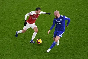 Arsenal V Cardiff City 2018-19 Prints: Arsenal's Mesut Ozil Clashes with Cardiff's Aron Gunnarsson in Premier League Showdown