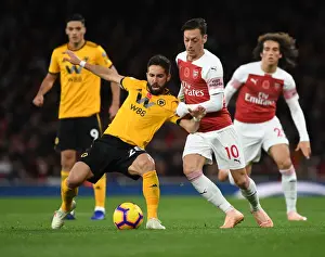 Arsenal V Wolverhampton Wanderers 2018-19 Prints: Arsenal's Mesut Özil Clashes with João Moutinho in Premier League Showdown (Arsenal v Wolverhampton Wanderers)