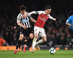 Arsenal V Newcastle United 2018-19 Prints: Arsenal's Mesut Ozil Clashes with Newcastle's Ki Sung-Yueng in Premier League Showdown