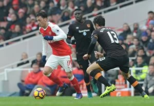 Images Dated 11th February 2017: Arsenal's Mesut Ozil Faces Off Against Hull City's Andrea Ranocchia in Premier League Clash