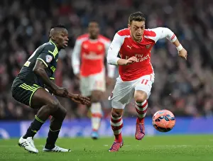 Arsenal V Middlesbrough - FA Cup 2014-15 Prints: Arsenal's Mesut Ozil Outmaneuvers Middlesbrough's Albert Adomah in FA Cup Fifth Round Clash