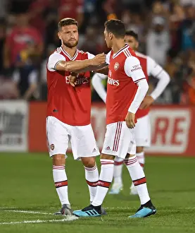 Arsenal's Mesut Ozil Receives Captain's Armband from Shkodran Mustafi during Colorado Rapids Match, 2019