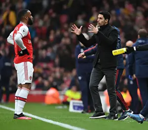 Arsenal V West Ham United 2019-20 Prints: Arsenal's Mikel Arteta Coaches Alexis Lacazette Amidst Premier League Clash Against West Ham