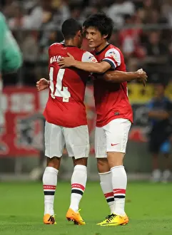 Nagoya Grampus V Arsenal 2013-14 Prints: Arsenal's Miyaichi and Walcott Celebrate Goal in Nagoya Grampus Match, 2013