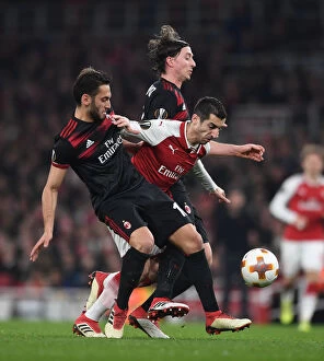 Images Dated 15th March 2018: Arsenal's Mkhitaryan Goes Head-to-Head with Calhanoglu and Montolivo of AC Milan in Europa League