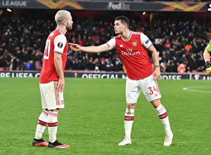 Arsenal's Mustafi and Xhaka in Action: A Europa League Battle against Olympiacos