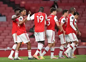 Arsenal's Nelson and Pepe Celebrate Goals in Empty Emirates Stadium: Arsenal vs. Liverpool, Premier League 2019-2020