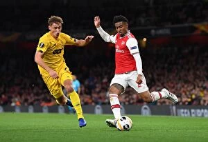 Arsenal v Standard Liege 2019-20 Collection: Arsenal's Nelson vs Vojvoda: A Europa League Battle at Emirates Stadium