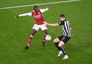 Arsenal's Nicolas Pepe Clashes with Newcastle's Paul Dummett in FA Cup Third Round