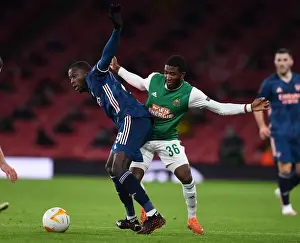 Arsenal's Nicolas Pepe Clashes with Rapid Wien's Kelvin Arase in Europa League Showdown