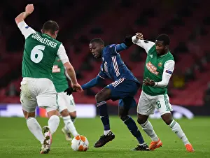 Arsenal V SK Rapid Wien 2020-21 Prints: Arsenal's Nicolas Pepe Faces Off Against Rapid Wien's Kelvin Arase in Europa League Clash