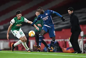 Arsenal's Nicolas Pepe Faces Off Against Rapid Wien's Leo Greiml in Empty Emirates Stadium - UEFA Europa League 2020-21