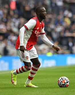 Tottenham Hotspur v Arsenal - The Mind Series 2021-22 Collection: Arsenal's Nicolas Pepe Faces Off Against Tottenham Hotspur in Intense Showdown