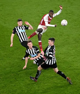 Arsenal's Nicolas Pepe Faces Pressure from Newcastle's Defense in FA Cup Clash