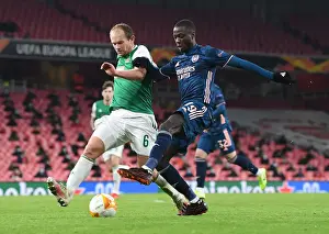 Arsenal's Nicolas Pepe Goes Head-to-Head with Rapid Wien's Mario Sonnleitner in Empty Emirates Stadium - UEFA Europa League 2020-21