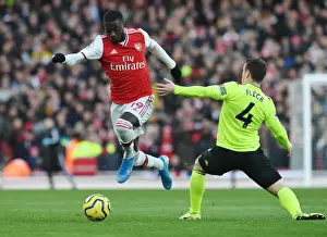 Arsenal V Sheffield United 2019-20 Prints: Arsenal's Nicolas Pepe Outmaneuvers Sheffield United's John Fleck during the Premier League Clash