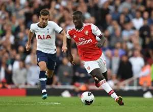Arsenal's Nicolas Pepe Outmaneuvers Tottenham's Harry Winks in the 2019-20 Premier League Clash
