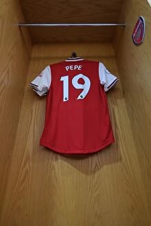Arsenal v Aston Villa 2019-20 Collection: Arsenal's Nicolas Pepe Prepares for Aston Villa Clash in Emirates Stadium Changing Room