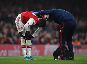 Arsenal's Nicolas Pepe Receives Treatment from Physio during Arsenal v Manchester United (2019-20)