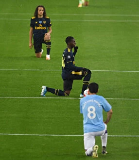 Manchester City v Arsenal 2019-20 Collection: Arsenal's Nketiah Kneels Before Manchester City: Premier League Showdown (2019-20)