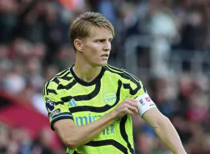 Arsenal's Odegaard Adjusts Captain's Armband in AFC Bournemouth Clash (2023-24)
