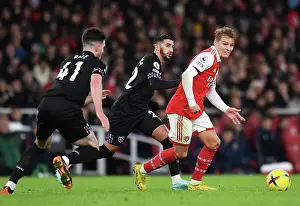 Arsenal's Odegaard Faces Pressure from West Ham's Benrahma in Premier League Clash