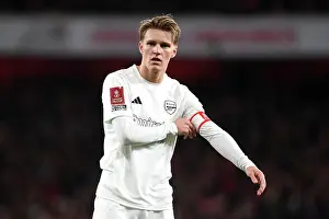 Arsenal's Odegaard Stares Intensely in All-White: A Moment of Focus Amidst No More Red Campaign during Arsenal vs. Liverpool FA Cup Clash