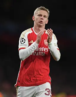 Arsenal's Oleksandr Zinchenko Celebrates with Fans after Victory over Sevilla in 2023-24 UEFA Champions League